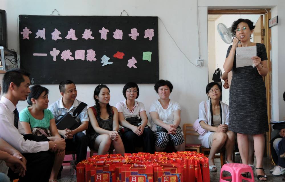 Zhao Xinling (right) speaking during a care event for children with autism at the "Loving Home for Children" Special Education and Rehabilitation Centre. Photo by Li Jingya/XINHUA