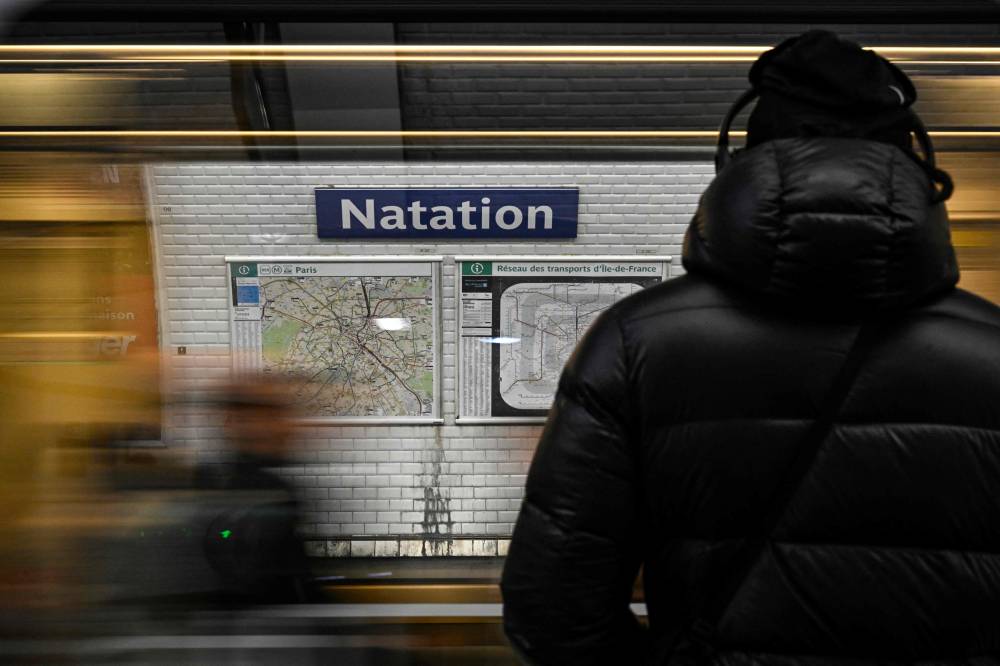 A person stands at a platform of the Paris' metro station Nation renamed on All Fools' Day as "Natation" as a reference to the upcoming Paris 2024 Olympics on April 1, 2024. (Photo by AFP)