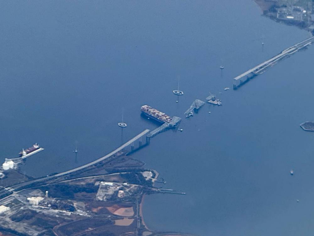 This aerial photo shows the collapsed Francis Scott Key Bridge lying on top of the container ship Dali in Baltimore, Maryland, March 31, 2024, as cleanup efforts begin.  - (Photo by Daniel Slim/AFP)