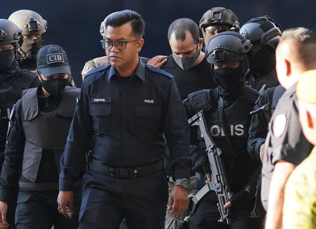 Israeli national Shalom Avitan, 38, who was arrested for possessing firearms, heavily escorted by the police at the Kuala Lumpur Courts Complex, today. - Photo by ROSLI TALIB