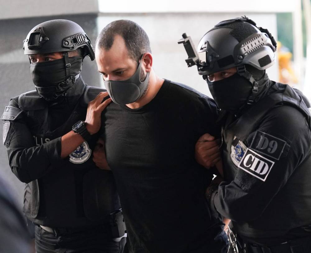 Israeli national Shalom Avitan, 38, who was arrested for possessing firearms heavily escorted by the police at the Kuala Lumpur Courts Complex, today. - Photo by ROSLI TALIB