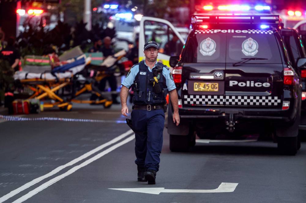 A police officer reacts outside the Westfield Bondi Junction shopping mall after a stabbing incident in Sydney on April 13, 2024. - Photo by AFP