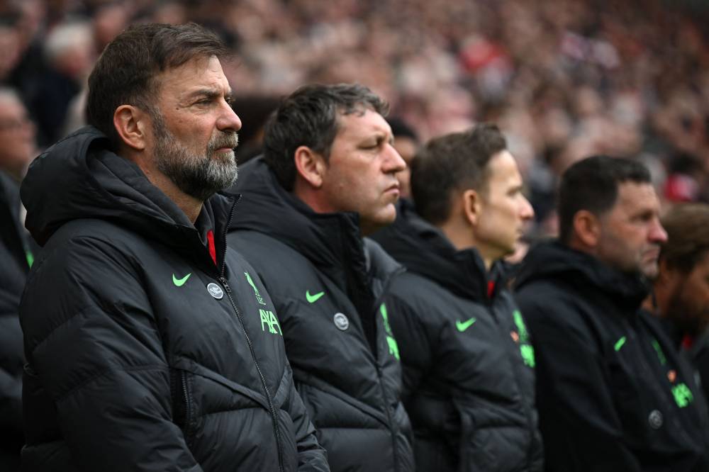 Liverpool's German manager Jurgen Klopp (L) and his assistants mark the 35th Anniversary of the Hillsborough disaster during a minute's silence ahead of the English Premier League football match between Liverpool and Crystal Palace at Anfield in Liverpool, north west England on April 14, 2024. - Photo by AFP