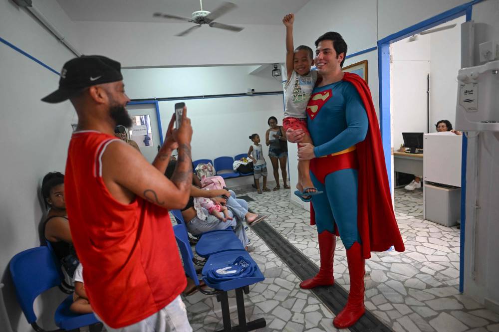 Muylaert liked the idea and jumped on a Superman costume, and since then, he has been traveling around Brazil as Superman. - Photo by AFP
