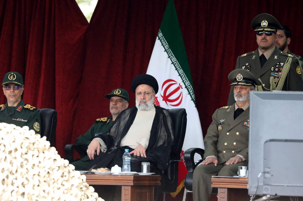 Iran's President Ebrahim Raisi attends a military parade alongside high-ranking officials and commanders during a ceremony marking the country's annual army day in Tehran on April 17, 2024. (Photo by AFP)
