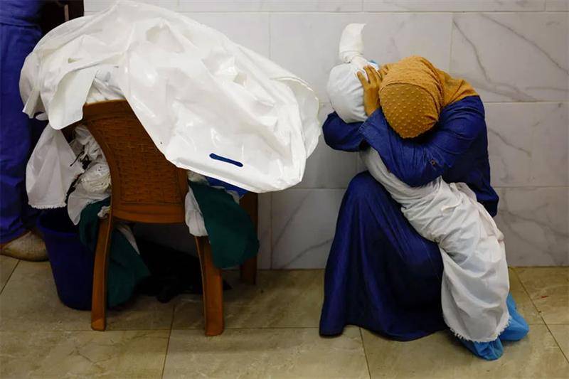 The picture taken by Reuters news agency's Mohammed Salem shows Inas Abu Maamar cradling the body of five-year-old Saly, who was killed with her mother and sister when a missile hit their home in Khan Younis in October.