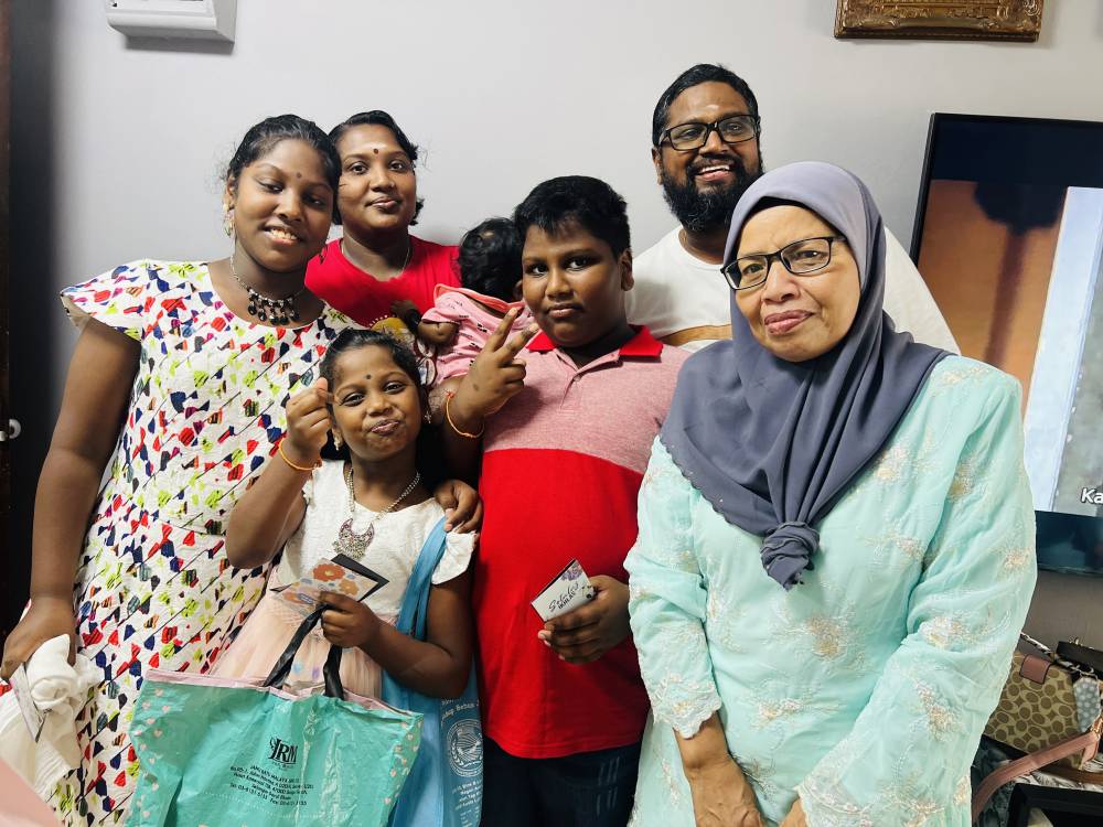Hasimah (right) with the Kumarasan family.