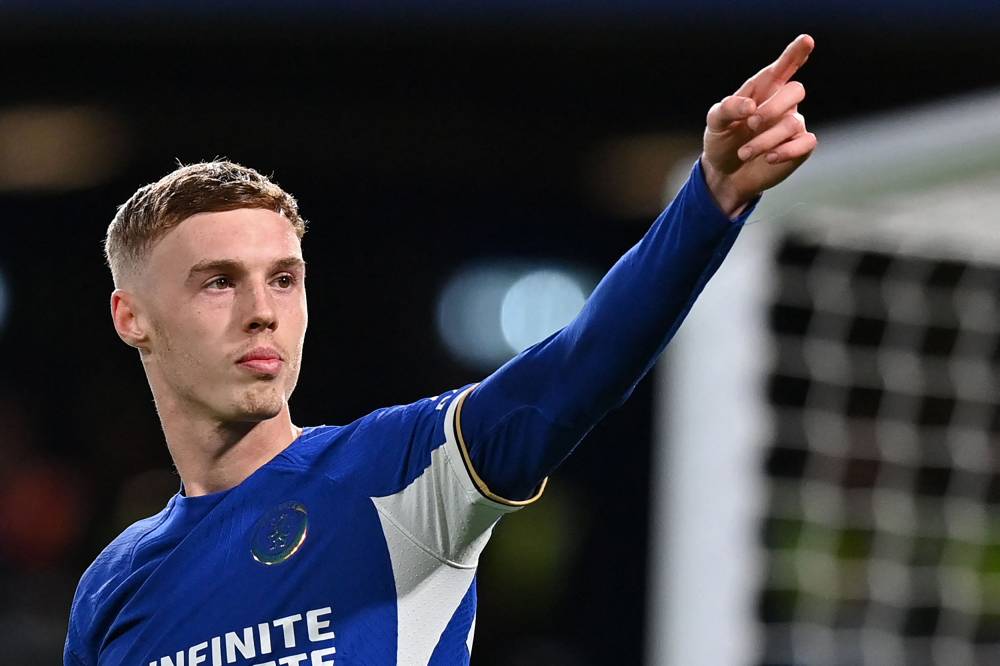 Chelsea's English midfielder #20 Cole Palmer celebrates after scoring his fourth goal, chelsea's fifth from the penalty spot during the English Premier League football match between Chelsea and Everton at Stamford Bridge in London on April 15, 2024. (Photo by AFP) 