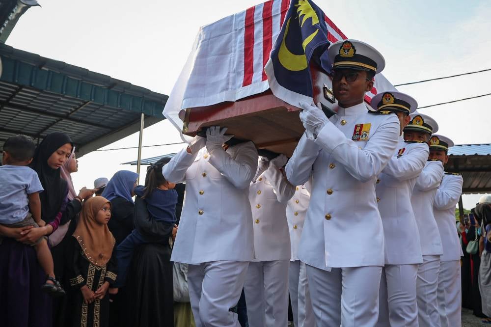 Remains of the Lumut helicopter crash victims were taken for prayers and given their last respects according to the official RMN funeral ceremony. Photo by Bernama