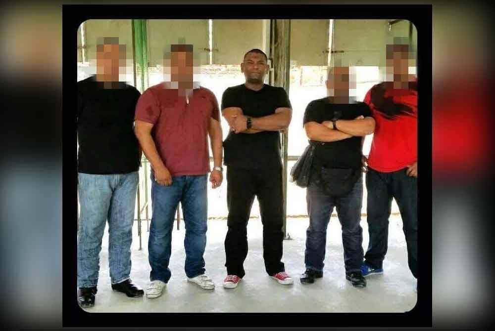 Nor Fazli (centre) with his fellow comrades, who also serve as personal bodyguards for celebrities.