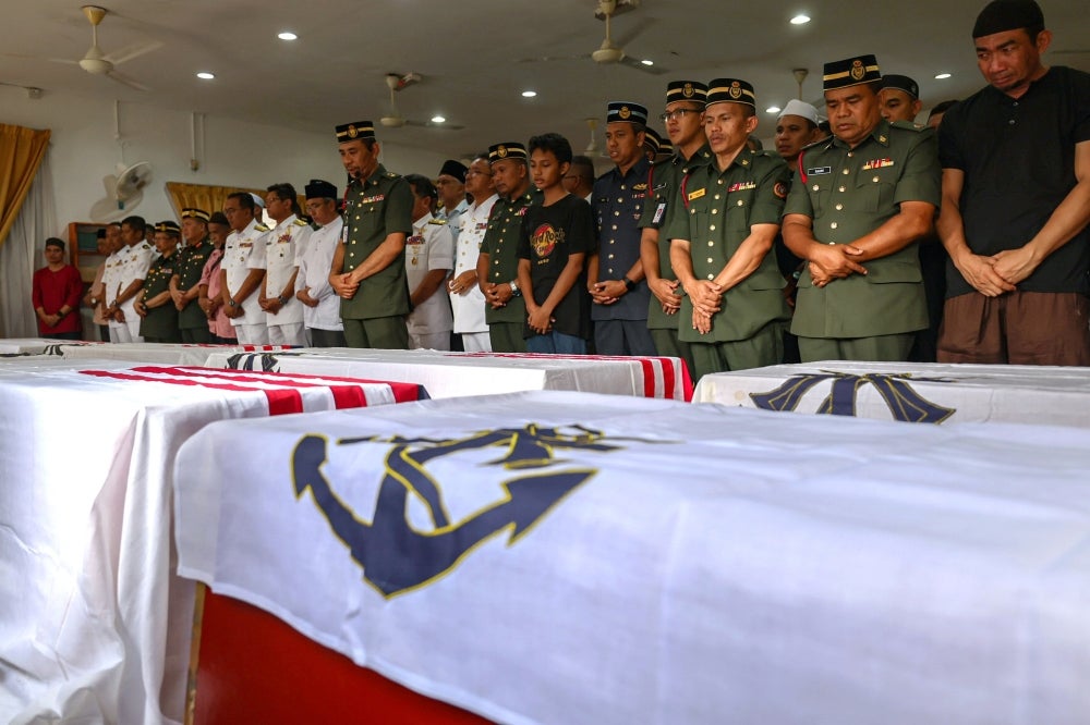 The remains of the eight victims of the helicopter crash at the RMN Base Lumut arrived at the Surau Salahuddin Al-Ayubi of the 23rd Battalion of the Royal Malay Regiment yesterday. Photo by Bernama