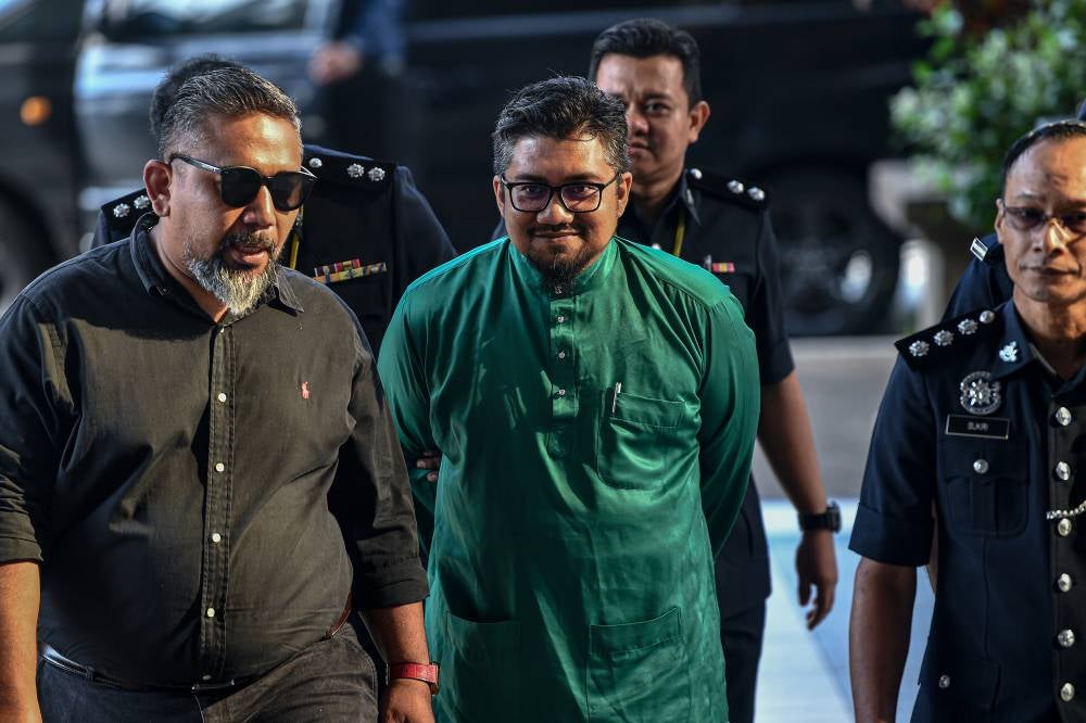 Bersatu Information Committee member Badrul Hisham Shaharin or Chegu Bard was charged in the Kuala Lumpur Sessions Court today with two counts of inciting hatred and issuing defamatory remarks which will tarnish the good name of His Majesty Sultan Ibrahim, King of Malaysia. - Photo by Bernama