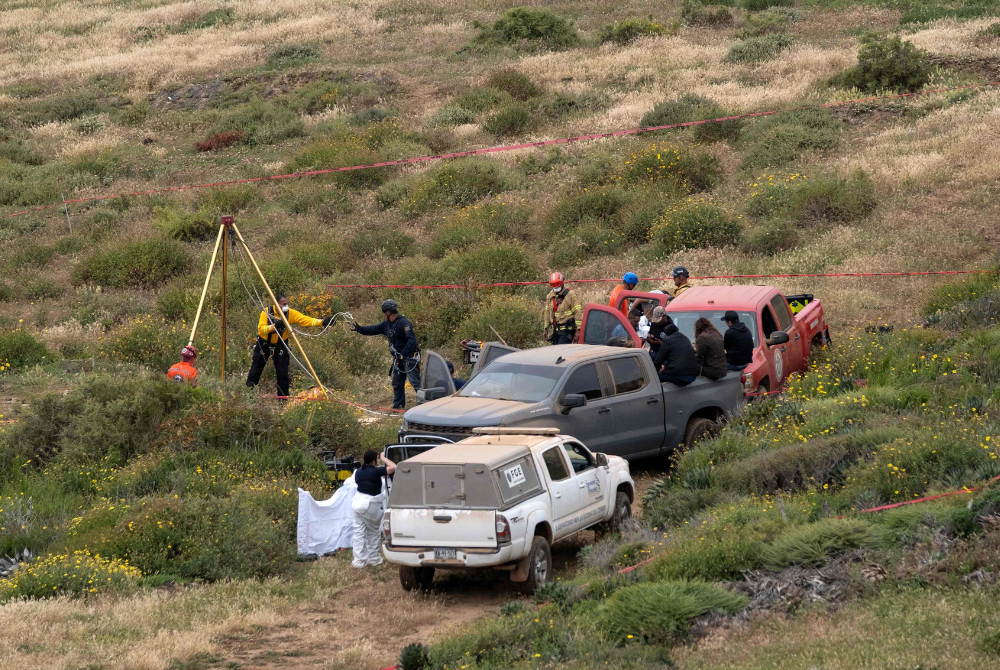 Rescue workers, forensics, and prosecutors work in a waterhole where human remains were found near La Bocana Beach, Santo Tomas delegation, in Ensenada, Baja California State, Mexico, on May 3, 2024. - Photo by AFP