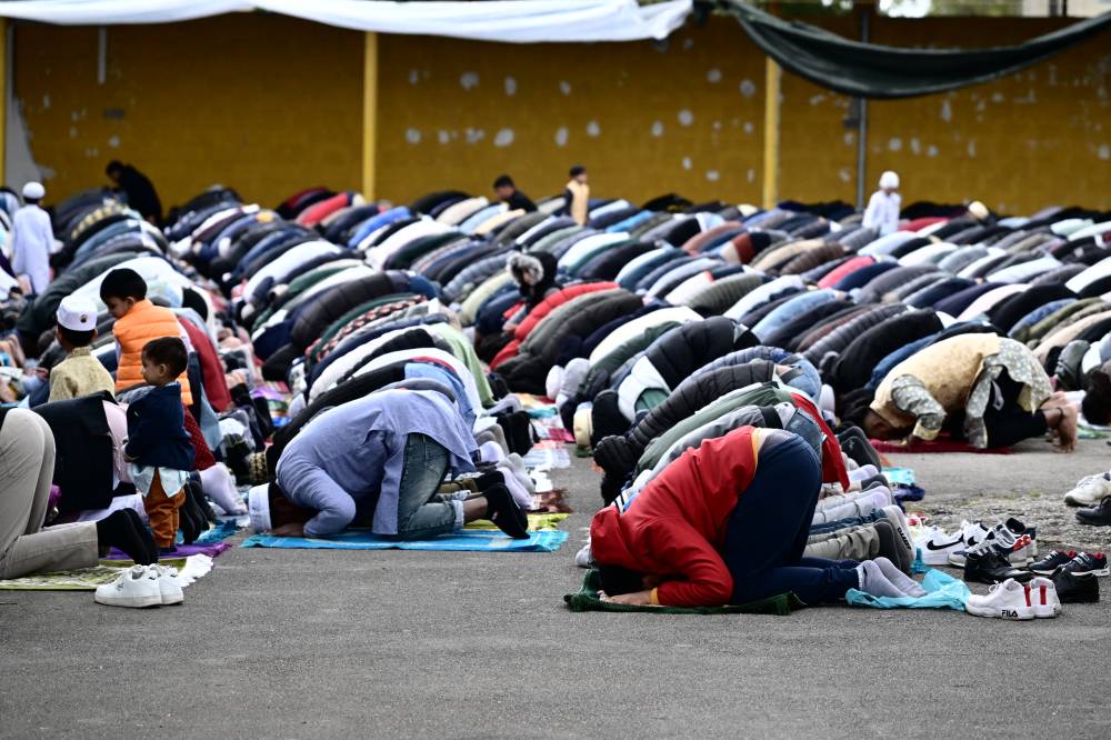 Muslims gather on the private parking lot of a construction site for the half-day prayer in Monfalcone, on April 26, 2024. - (Photo by ALBERTO PIZZOLI / AFP)