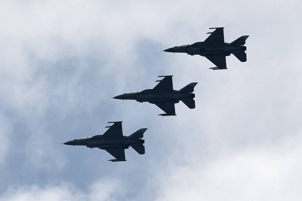This photograph taken on November 12, 2016 shows three Republic of Singapore Air Force F-16 aircraft flying during a media preview in Singapore. Photo by Roslan Rahman/AFP