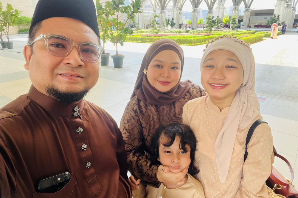 Ili Liyana Ihsan, two from left, with her husband, daughter and son.