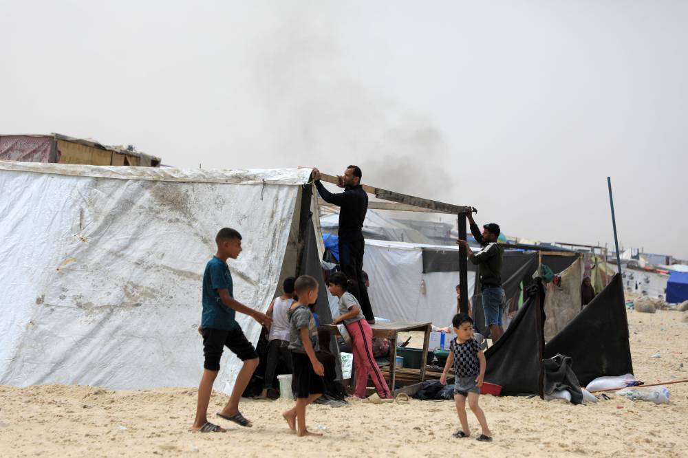 Palestinian people evacuated from Rafah set up a tent at a beach in the southern Gaza Strip city of Khan Younis, on May 10, 2024. (Photo by Rizek Abdeljawad/Xinhua)
