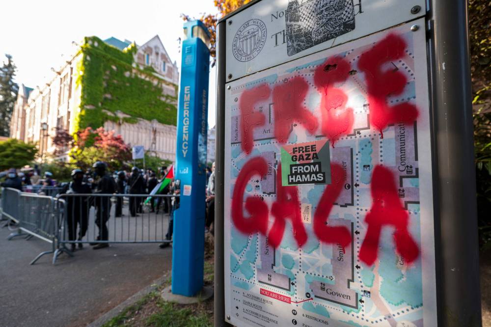 Graffiti reading "free Gaza" is painted on a map next to an encampment protesting the University of Washington's ties to Israel and Boeing at the University of Washington in Seattle, Washington, May 12, 2024. (Photo by AFP)