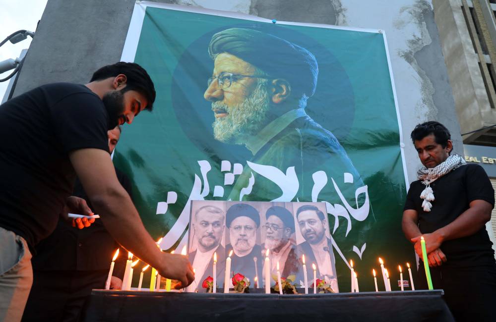 Iraqis light candles for its late president Ebrahim Raisi outside the Iranian embassy in Baghdad. Photo by Khalil Dawood/XINHUA