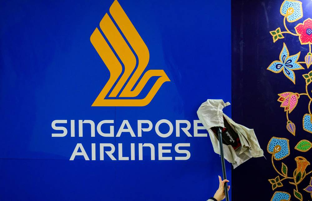 Singapore Airlines said on May 21, 2024 that one person died and others were injured after "severe turbulence" on a flight from London that made an emergency landing in Bangkok. - (Photo by John MACDOUGALL / AFP)