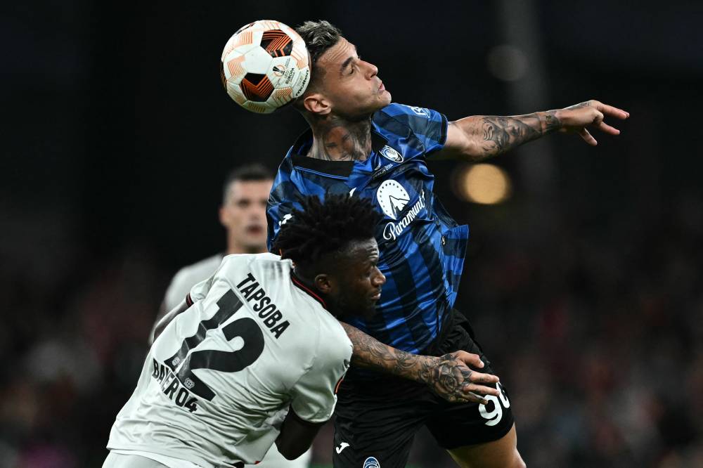Atalanta's Italian forward #90 Gianluca Scamacca heads the ball next to Bayer Leverkusen's Burkinabe defender #12 Edmond Tapsoba during the UEFA Europa League final football match between Atalanta and Bayer Leverkusen at the Dublin Arena stadium, in Dublin, on May 22, 2024. - Photo by AFP