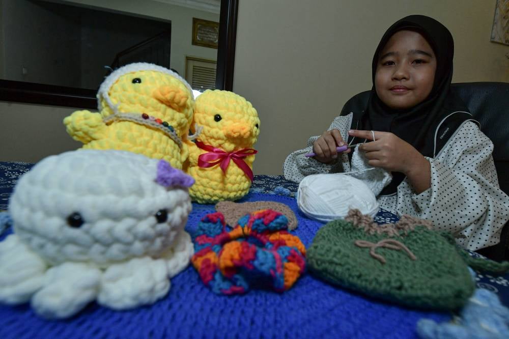 Delisha Maira Johan,11 with her handcrafted crafts. Photo by Bernama