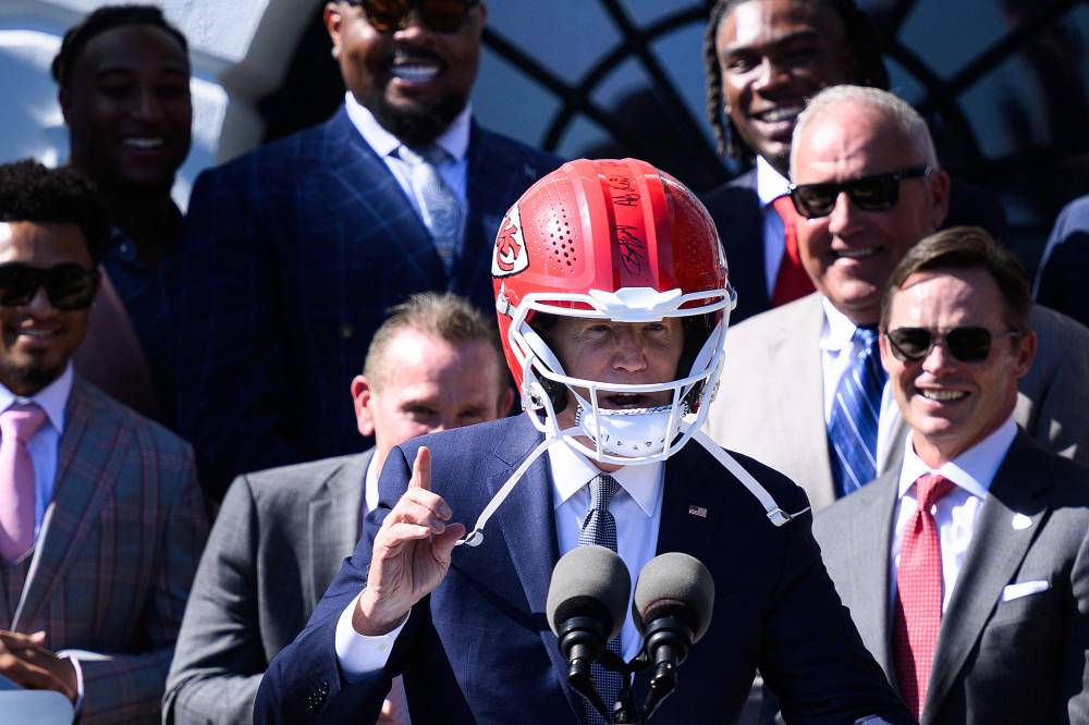 US President Joe Biden wears a Kansas City Chiefs helmet while speaking during a celebration for the Kansas City Chiefs, 2024 Super Bowl champions, on the South Lawn of the White House in Washington, DC, on May 31, 2024. (Photo by AFP)