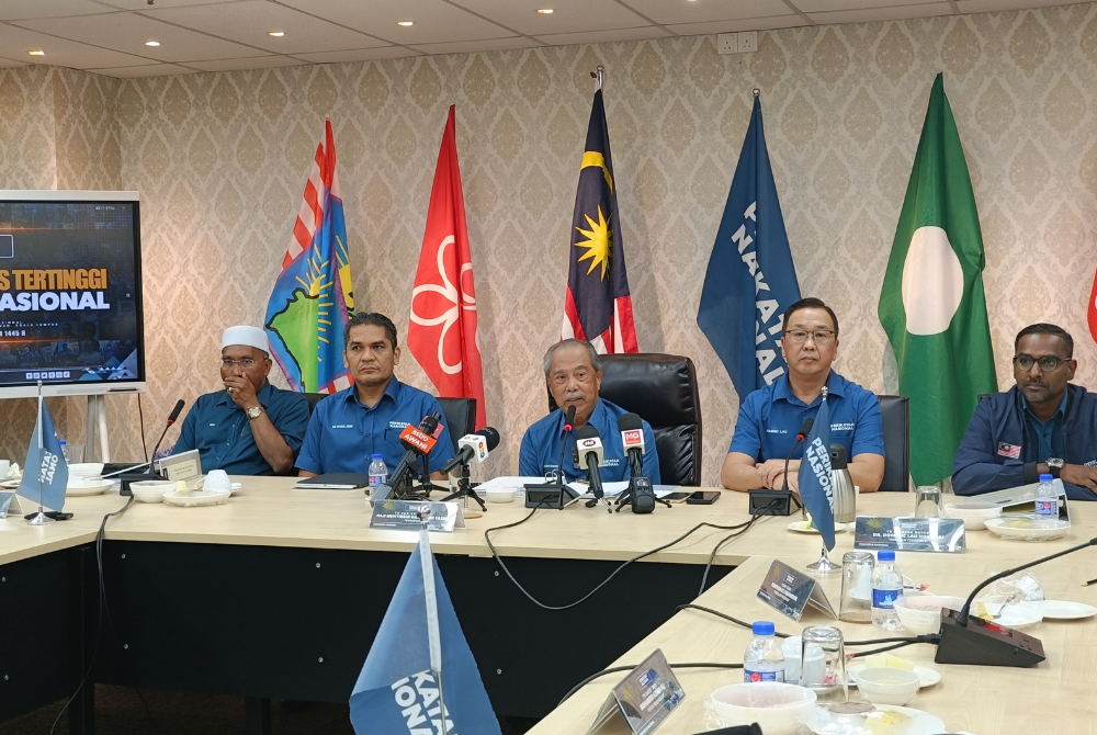 Muhyiddin (centre) during a press conference at PN headquarters in Kuala Lumpur yesterday.
