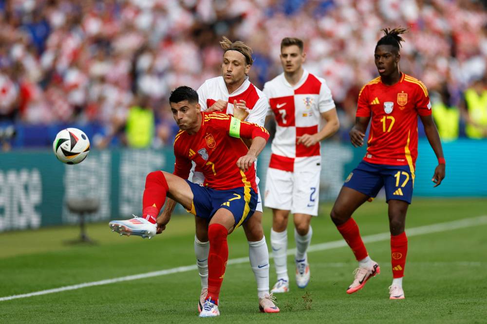 Spain's forward #07 Alvaro Morata (L) fights for the ball with Croatia's midfielder #07 Lovro Majer (2nd L) during the UEFA Euro 2024 Group B football match between Spain and Croatia at the Olympiastadion in Berlin on June 15, 2024. (Photo by Odd ANDERSEN / AFP)