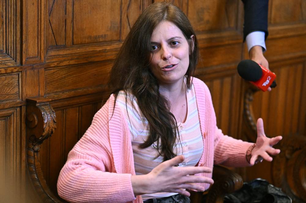 Italian teacher and activist Ilaria Salis, accused of attacking alleged neo-Nazis in Hungary, speaks at a court in Budapest on May 24, 2024 prior to the start of her trial for attacking neo-Nazis. (Photo by Attila KISBENEDEK / AFP)