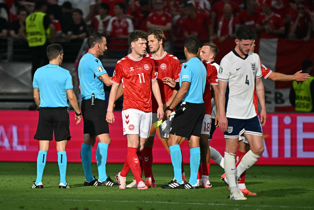 (From L) Portuguese referee Artur Soares Dias, Denmark's forward #11 Andreas Skov Olsen and England's midfielder #04 Declan Rice react at the end of the UEFA Euro 2024 Group C football match between Denmark and England at the Frankfurt Arena in Frankfurt am Main on June 20, 2024. (Photo by AFP)