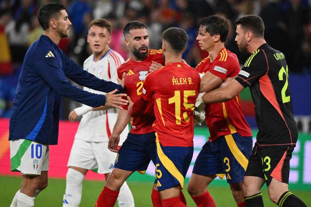 Spain's defender #02 Dani Carvajal (3L) and teammates celebrate on the pitch after the UEFA Euro 2024 Group B football match between Spain and Italy at the Arena AufSchalke in Gelsenkirchen on June 20, 2024. Spain won the game 1-0. (Photo by AFP)
