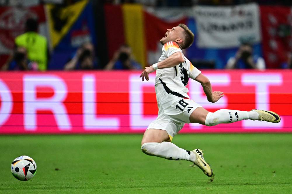 Germany's defender #18 Maximilian Mittelstaedt falls during the UEFA Euro 2024 Group A football match between Switzerland and Germany at the Frankfurt Arena in Frankfurt am Main on June 23, 2024. (Photo by AFP)