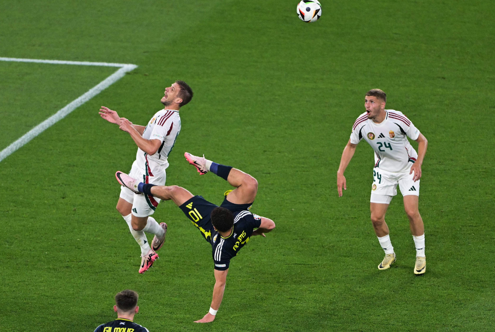Scotland's forward #10 Che Adams (C) kicks the ball next to Hungary's defender #24 Marton Dardai (R) during the UEFA Euro 2024 Group A football match between Scotland and Hungary at the Stuttgart Arena in Stuttgart on June 23, 2024. (Photo by AFP)