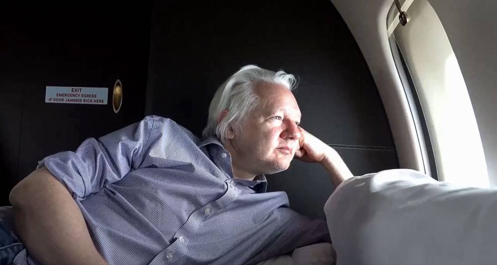 This frame grab taken from video posted on the WikiLeaks X account @wikileaks on June 25, 2024 shows WikiLeaks founder Julian Assange looking out of the window from a private jet as he flies from London to Saipan in the Northern Mariana Islands after reaching a plea deal with the US authorities. - Photo by AFP