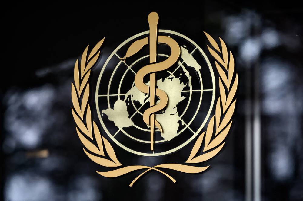 This photograph taken on Dec 7, 2021 shows a sign of WHO at their headquarters in Geneva. - (Photo by FABRICE COFFRINI / AFP)