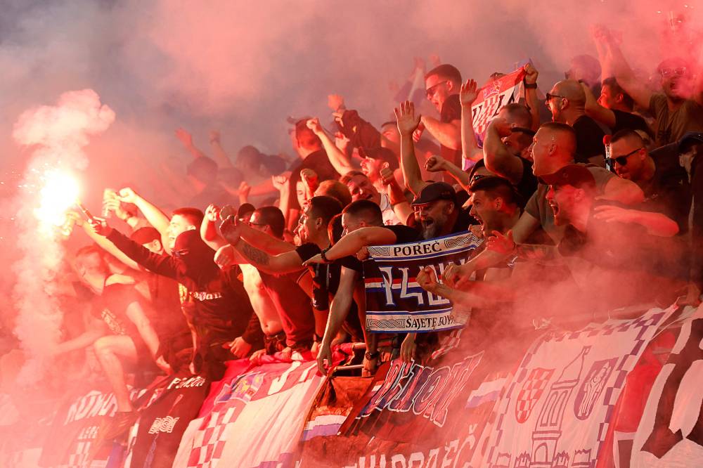 Supporters of Croatia celebrate after their team's first goal with flares during the UEFA Euro 2024 Group B football match between Croatia and Italy at the Leipzig Stadium in Leipzig on June 24, 2024. (Photo by AFP)