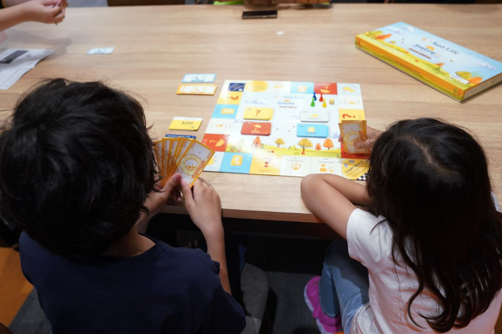 Children participating in the financial literacy board game. - Photo by Rosli Talib/Sinar