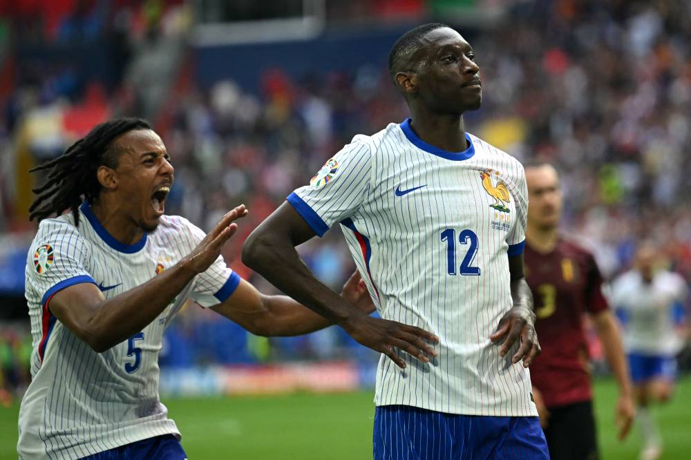 France's forward #12 Randal Kolo Muani (R) celebrates scoring his team's first goal during the UEFA Euro 2024 round of 16 football match between France and Belgium at the Duesseldorf Arena in Duesseldorf on July 1, 2024. (Photo by AFP)
