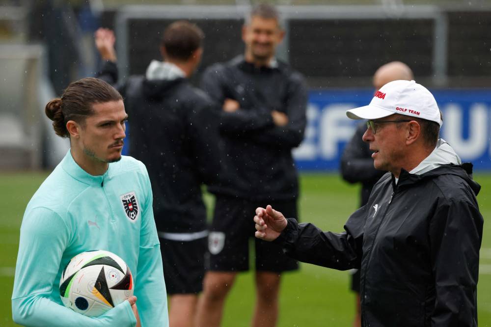 Austria's midfielder #09 Marcel Sabitzer (L) and Austria's head coach Ralf Rangnick attend a MD-1 training session at their base camp in Berlin on July 1, 2024, on the eve of their UEFA Euro 2024 Football Championship Round of 16 match against Turkey. (Photo by AFP)