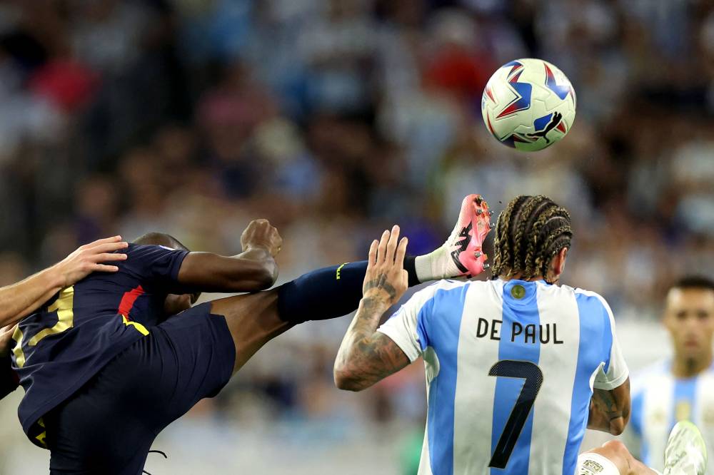 Ecuador's forward #13 Enner Valencia fights for the ball with Argentina's midfielder #07 Rodrigo De Paul during the Conmebol 2024 Copa America tournament quarter-final football match between Argentina and Ecuador at NRG Stadium in Houston, Texas, on July 4, 2024. (Photo by AFP)