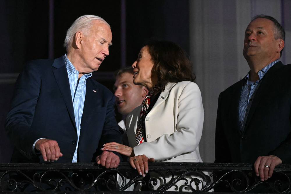 US President Joe Biden (L) speaks to US Vice President Kamala Harris (C) next to US Second Gentleman Doug Emhoff as they watch the Independence Day fireworks display from the Truman Balcony of the White House in Washington, DC, on July 4, 2024. (Photo AFP)