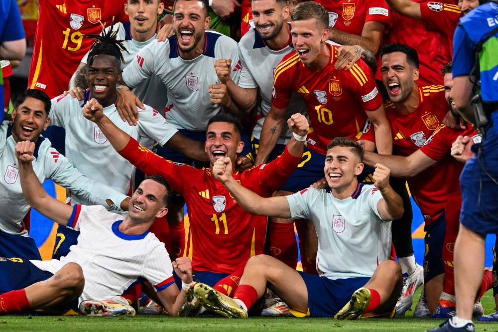 Spain's players celebrate after winning the UEFA Euro 2024 semi-final football match between the Spain and France at the Munich Football Arena in Munich on July 9, 2024. (Photo by AFP)