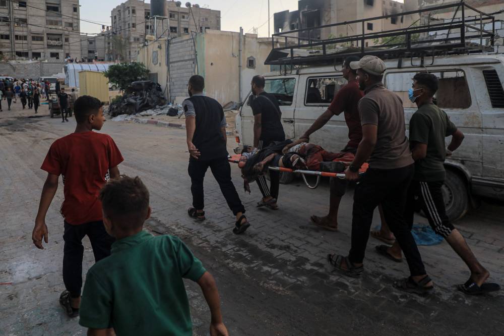 People transfer victims after an Israeli bombing in the southern Gaza Strip city of Khan Younis, on July 9, 2024. (Photo by Xinhua)