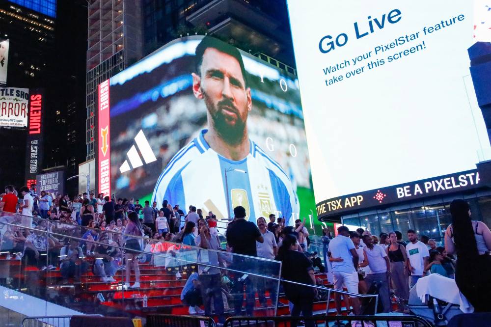 Argentina's forward Lionel Messi appears on a screen as Argentina's supporters gather at Times Square, New York City after the Conmebol 2024 Copa America tournament semi-final football match between Argentina and Canada on July 9, 2024. (Photo by AFP)