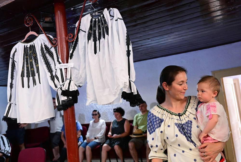 Villagers in Vaideeni at the foot of Romania's Carpathian mountains are fuming at French luxury brand Louis Vuitton for "stealing" the design of their traditional blouse. Photo by Daniel Mihailescu/AFP