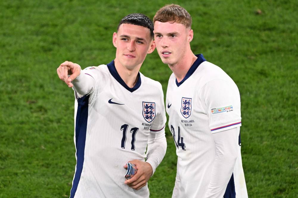England's midfielder #11 Phil Foden and England's midfielder #24 Cole Palmer celebrate at the end of the UEFA Euro 2024 semi-final football match between the Netherlands and England at the BVB Stadion in Dortmund on July 10, 2024. (Photo by AFP)
