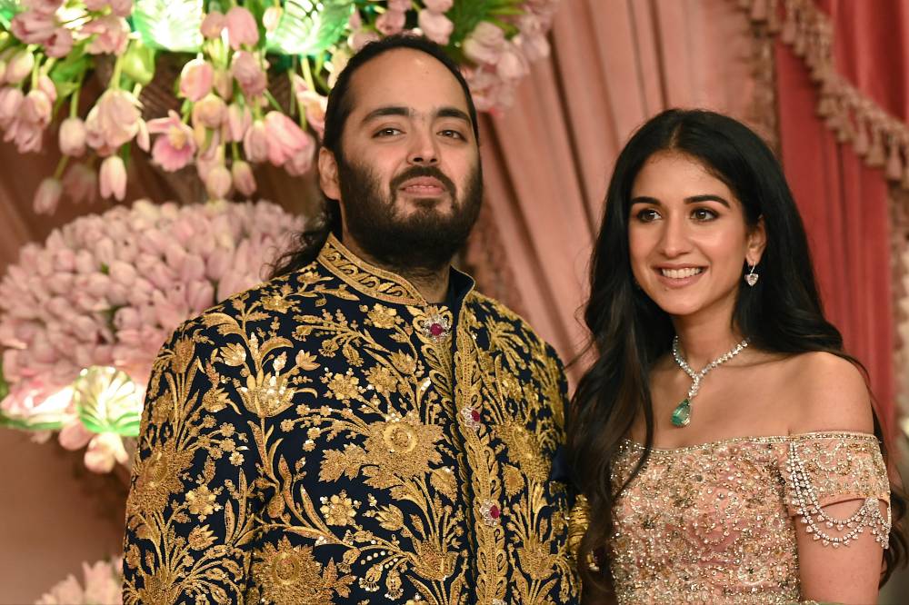 Anant Ambani son of billionaire tycoon and Chairman of Reliance Industries Mukesh Ambani (unseen) with his fiancee Radhika Merchant pose for a picture during their Sangeet Ceremony in Mumbai, on July 5, 2024. - (Photo by SUJIT JAISWAL / AFP)