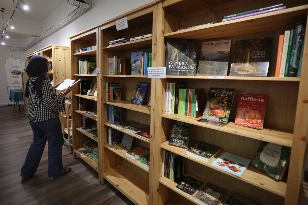 Visitors can find a collection of books related to nature at the Sunda Shelves bookstore and cafe in Damansara Kim. - Photo by Bernama
