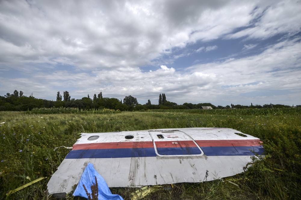 (FILES) A wreckage of the Malaysia Airlines flight MH17 is seen in a field near the village of Grabove, in the region of Donetsk on July 20, 2014. (Photo by Bulent KILIC / AFP)